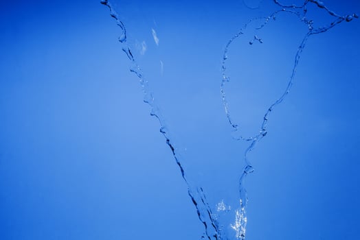 Falling water on a blue background photo