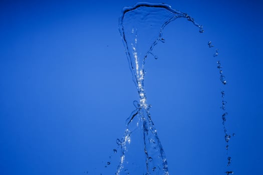 Falling water on a blue background photo