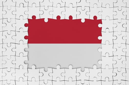 Indonesia flag in frame of white puzzle pieces with missing central part photo