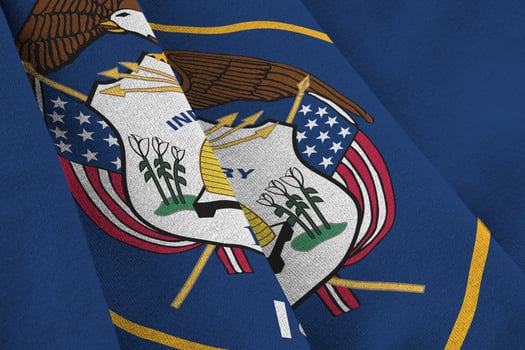 Utah US state flag with big folds waving close up under the studio light indoors. The official symbols and colors in banner photo