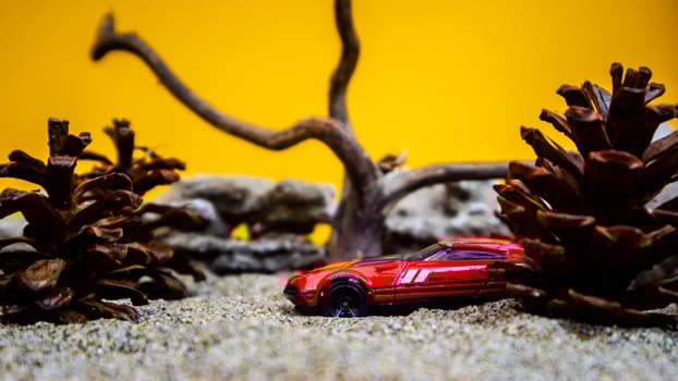 Minahasa, Indonesia  saturday, December 2022, a toy car among the pinecones photo