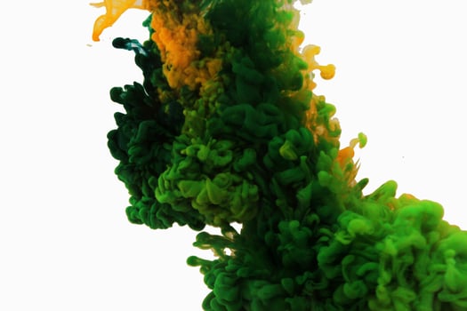abstract background colour in water yellow green blue on white background in water with a white background. like abstract-style smoke paintings photo