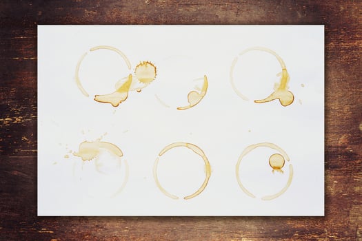 paper stained coffee on wood background with space photo