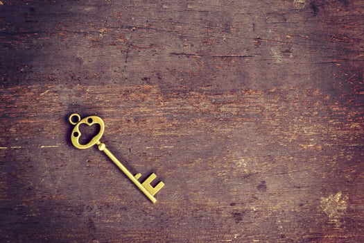 old key on wood background with space photo