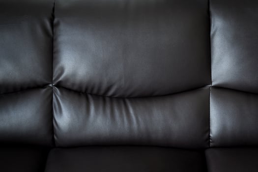 close up black leather sofa and textured and background with space. photo