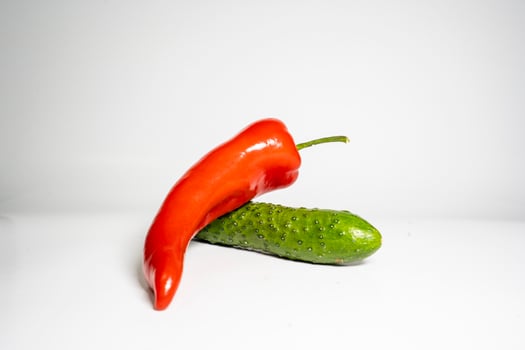 Fresh Cucumber and red pepper isolated on white background tasty and healthy food flat side view photo