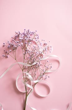 Pink tablet for text with a background of white flowers and ribbon photo