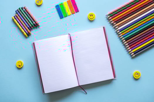 A set of bright stationery items on a blue background. Colour pencils photo