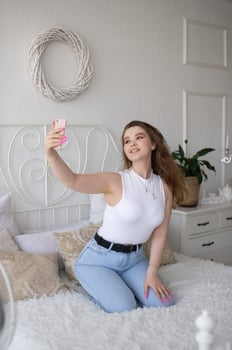 A happy woman has a selfie. The girl looks into the phone camera and smiles. photo