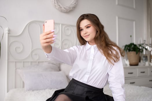 A happy woman has a video call. The girl looks into the phone camera and smiles. photo