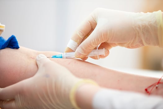 The doctor makes an injection into the patient's vein. photo