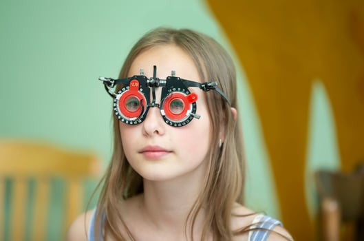 A girl in special glasses for the treatment of vision problems. photo
