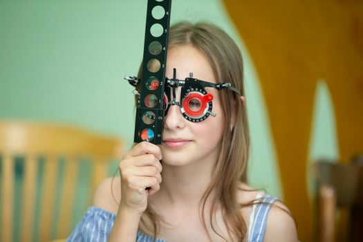 A girl in special glasses for the treatment of vision problems. photo