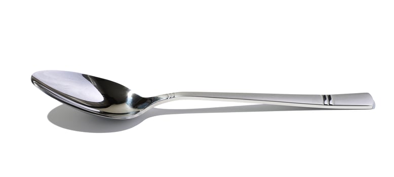 Metal spoon for soup on a white isolated background photo