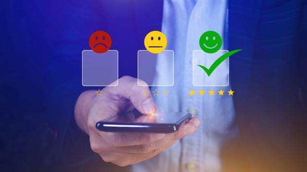 Customer service evaluation concept feedback rating and positive customer review experience, using a smartphone And pressing face emoticon smile in satisfaction on virtual touch screen photo