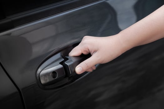 Woman hand open car door,hand pulling a car's door handle photo