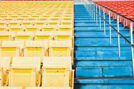 Empty orange and yellow seats at stadium,Rows of seat on a soccer stadium photo