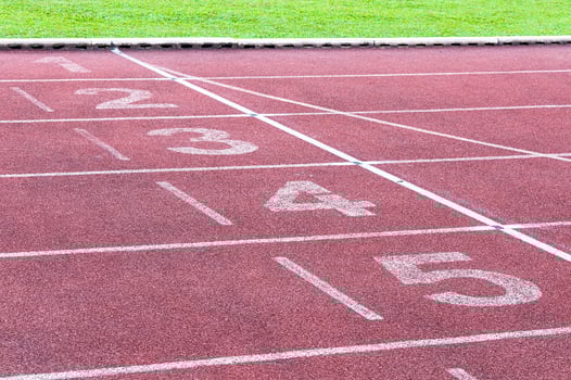 Numbers starting point on red running track,running track and green grass,Direct athletics Running track at Sport Stadium photo