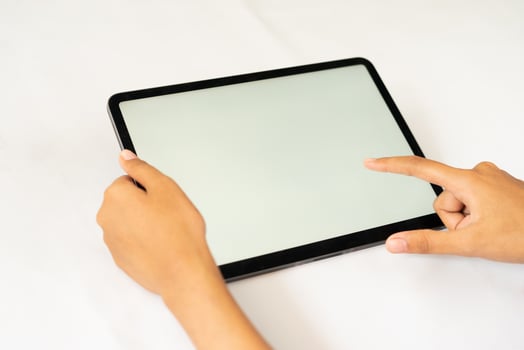 Hand holding blank digital tablet for mockups photo