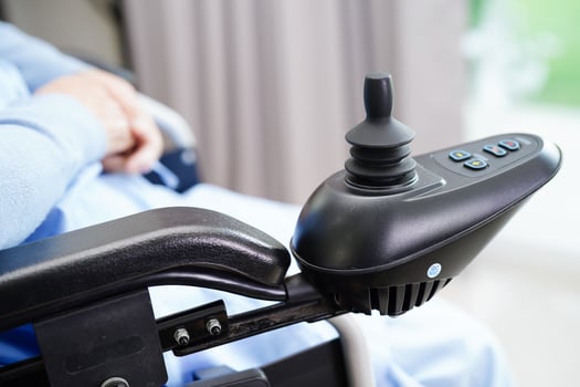 Asian elderly woman disability patient sitting on electric wheelchair in park, medical concept. photo