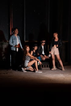 a group of teenagers in quirky clothes posing together as friends in a disco bar with a very cool expression photo