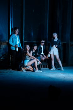 a group of teenagers in quirky clothes posing together as friends in a disco bar with a very cool expression photo