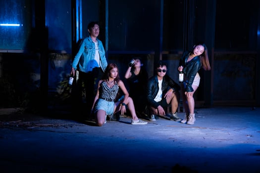 a group of teenagers in quirky clothes posing together as friends in a disco bar with a very cool expression photo