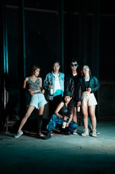 a group of women and men in modern clothes taking pictures together in a clubbing place while celebrating the new year photo