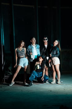 a group of women and men in modern clothes taking pictures together in a clubbing place while celebrating the new year photo