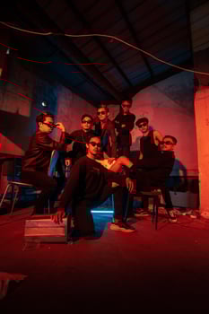 a group of delinquent teenagers wearing glasses and black clothes were sitting and gathering with their friends photo