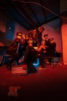 a group of delinquent teenagers wearing glasses and black clothes were sitting and gathering with their friends photo