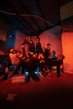 a group of thugs wearing dark clothes and glasses were having fun chatting with their friends in an old building photo