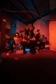 a group of thugs wearing dark clothes and glasses were having fun chatting with their friends in an old building photo