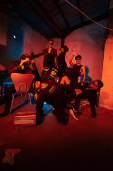 a group of thugs wearing dark clothes and glasses were having fun chatting with their friends in an old building photo