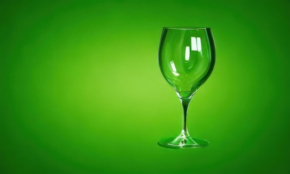 wine transparent glass on green background photo