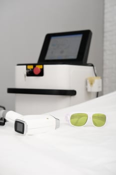 Laser epilation machine in beauty salon. Body care and cosmetology concept, Hair removal apparatus photo