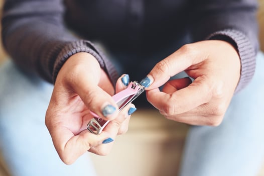 cut nails concept, woman hand holding nail clipper and cutting nails hand - fingernail health care photo