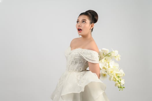 Young asian beautiful bride pose with excited feel on white background photo