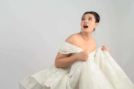 Young asian beautiful bride pose with excited feel on white background photo