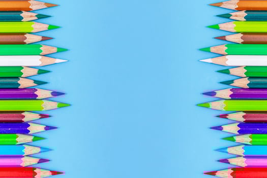 Collor wooden pencils in row isolated on bluebackground. Top view with copy space. photo