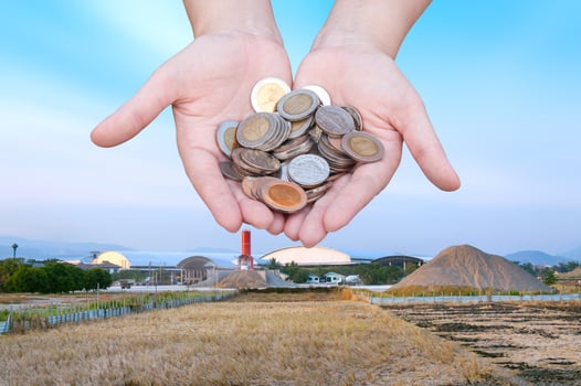 Coins in hands on Industry Landscape background,Donation Investment Fund Financial Support Charity  Dividend Market  Wealthy Giving Planned Accounting Collection Debt photo