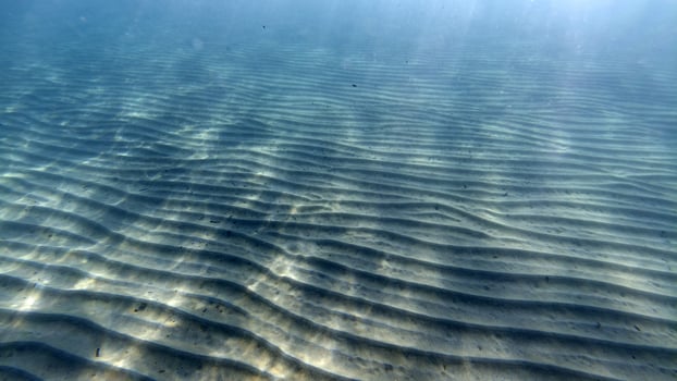 sand bottom underwater swimming in turquoise lagoon photo