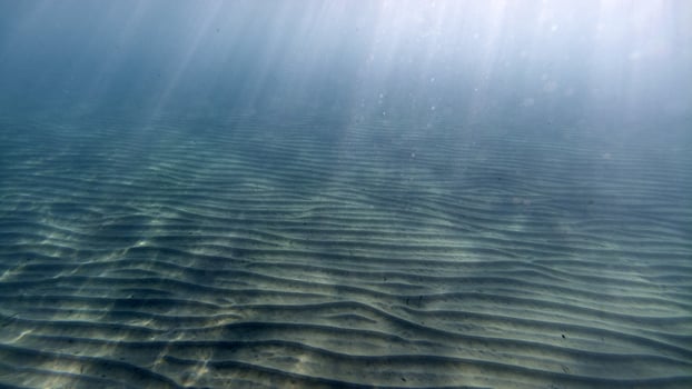 sand bottom underwater swimming in turquoise lagoon photo