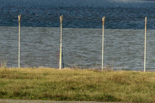 barbed wire fence detail near the sea photo