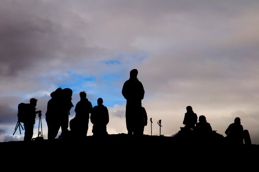 A group of trekkers black silhouette in the cloudy sky background photo