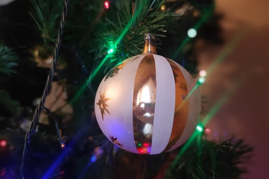 glass hand made christmas ball on xmas tree detail blur lights photo