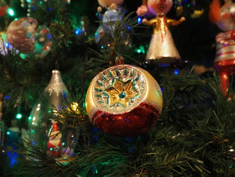 glass hand made christmas ball on xmas tree detail blur lights photo