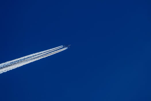 jet airplaine wakes on blue sky photo