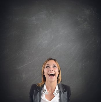 Businesswoman screaming on dark background photo