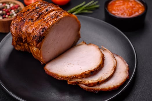 Delicious fresh smoked meat or ham with spices and herbs photo